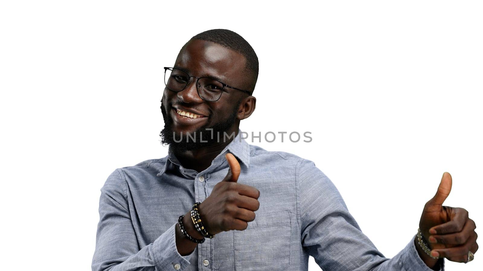 A man, close-up, on a white background, shows his thumbs up.