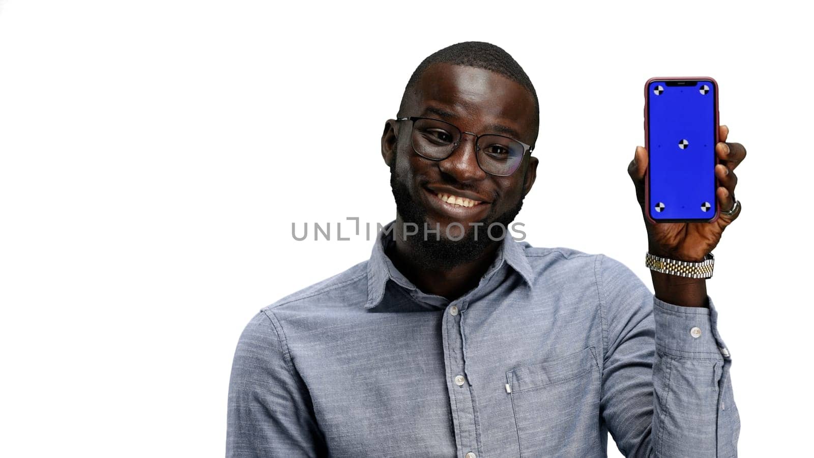 A man, close-up, on a white background, shows a phone by Prosto