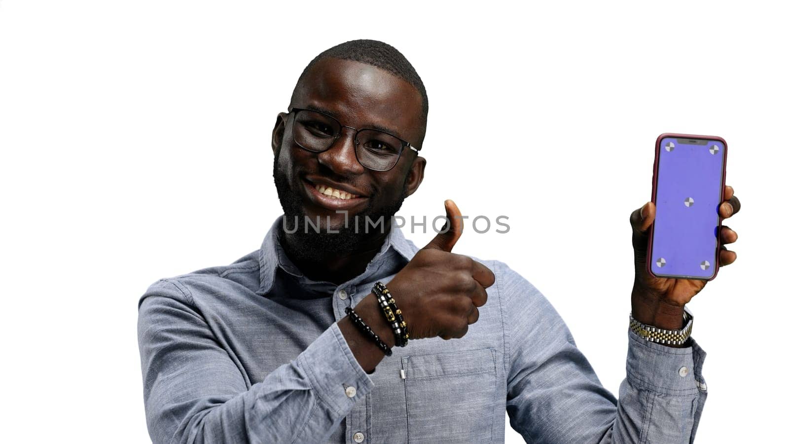 A man, close-up, on a white background, shows a phone by Prosto