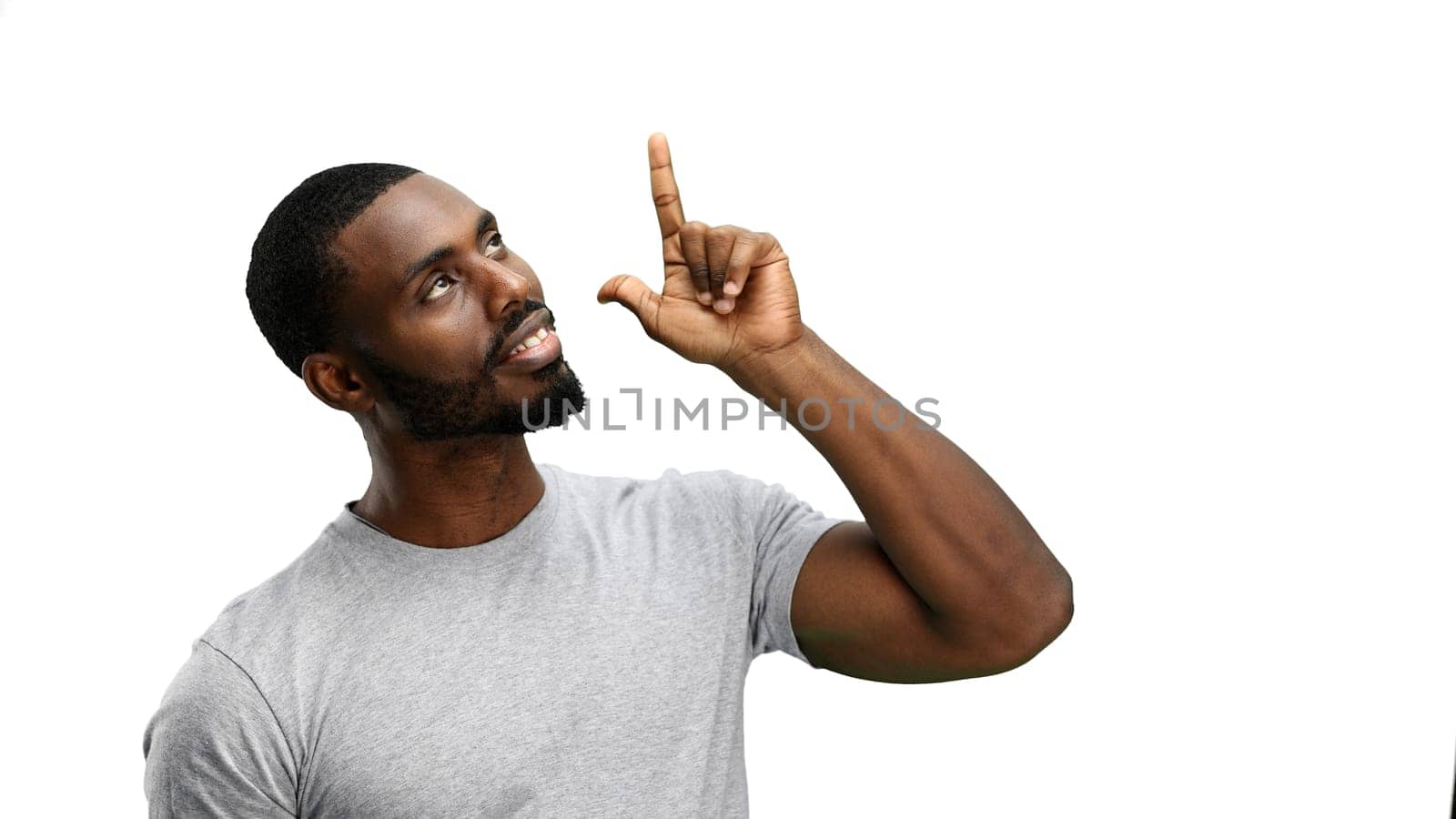 Man, close-up, on a white background, pointing up.