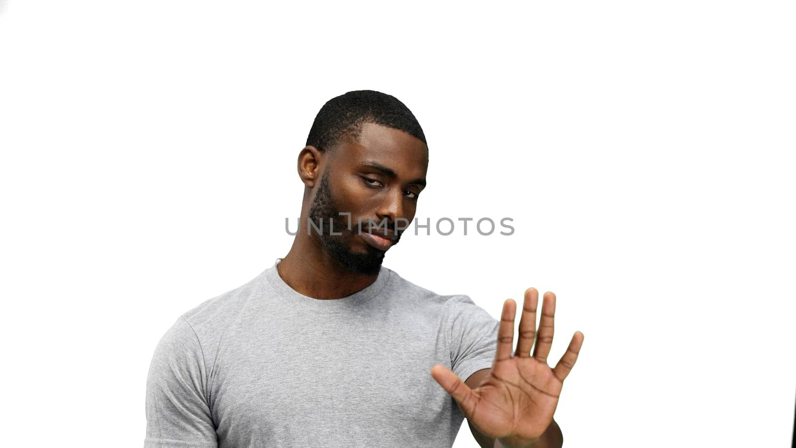 A man, close-up, on a white background, shows a stop sign by Prosto