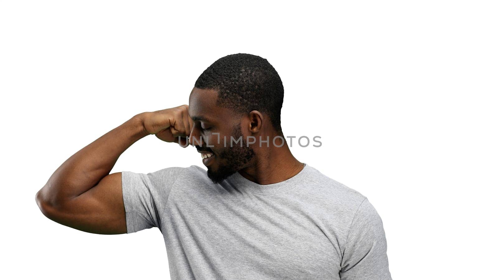 Man, close-up, on a white background, shows strength.