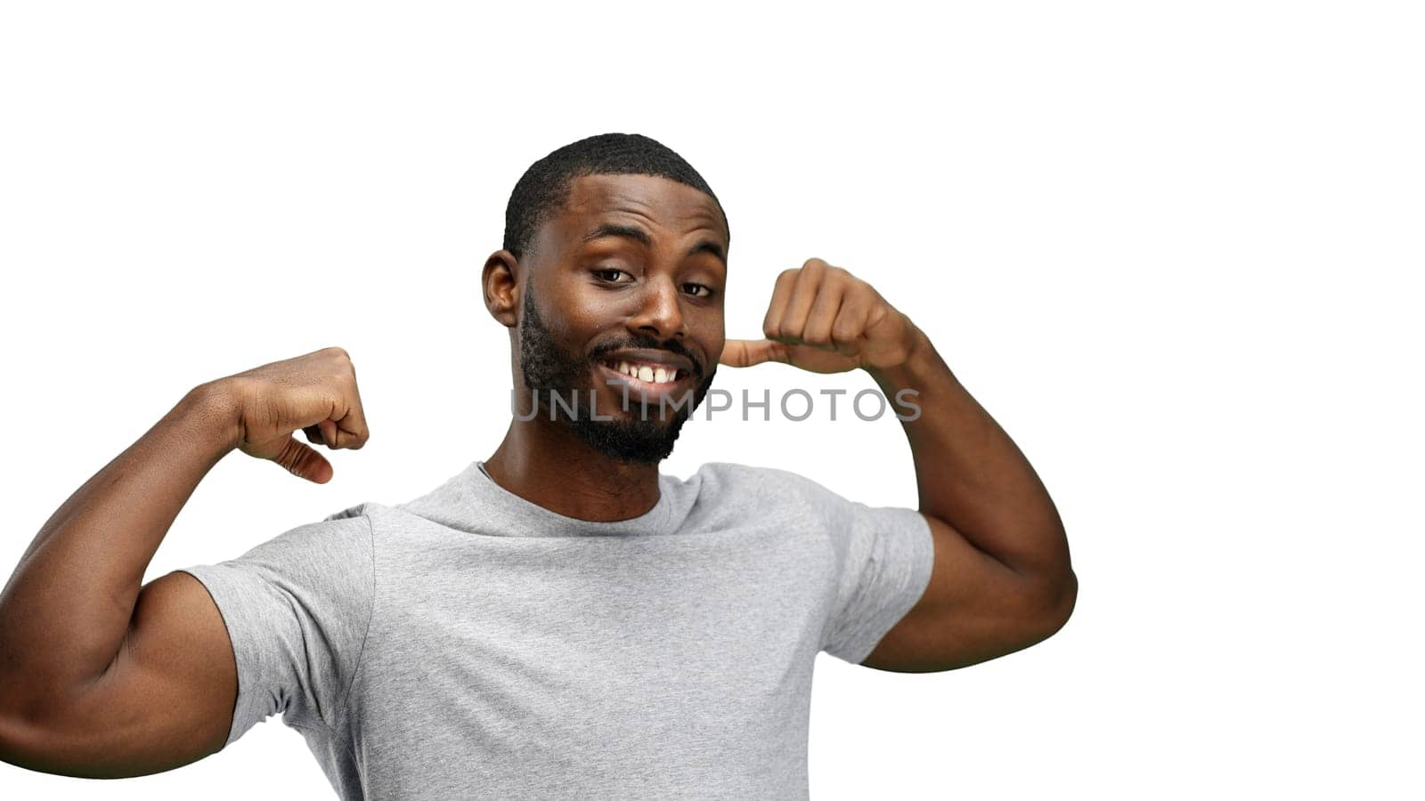 Man, close-up, on a white background, shows strength.