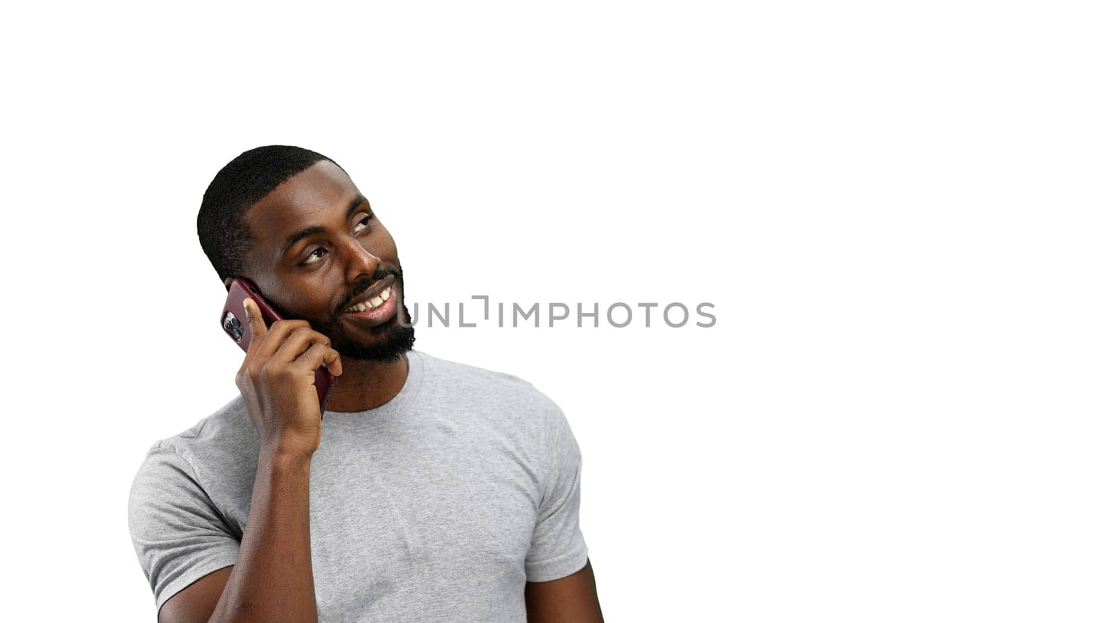 Man, close-up, on a white background, talking on the phone.