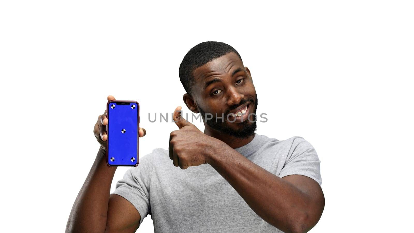 A man, close-up, on a white background, shows a phone.