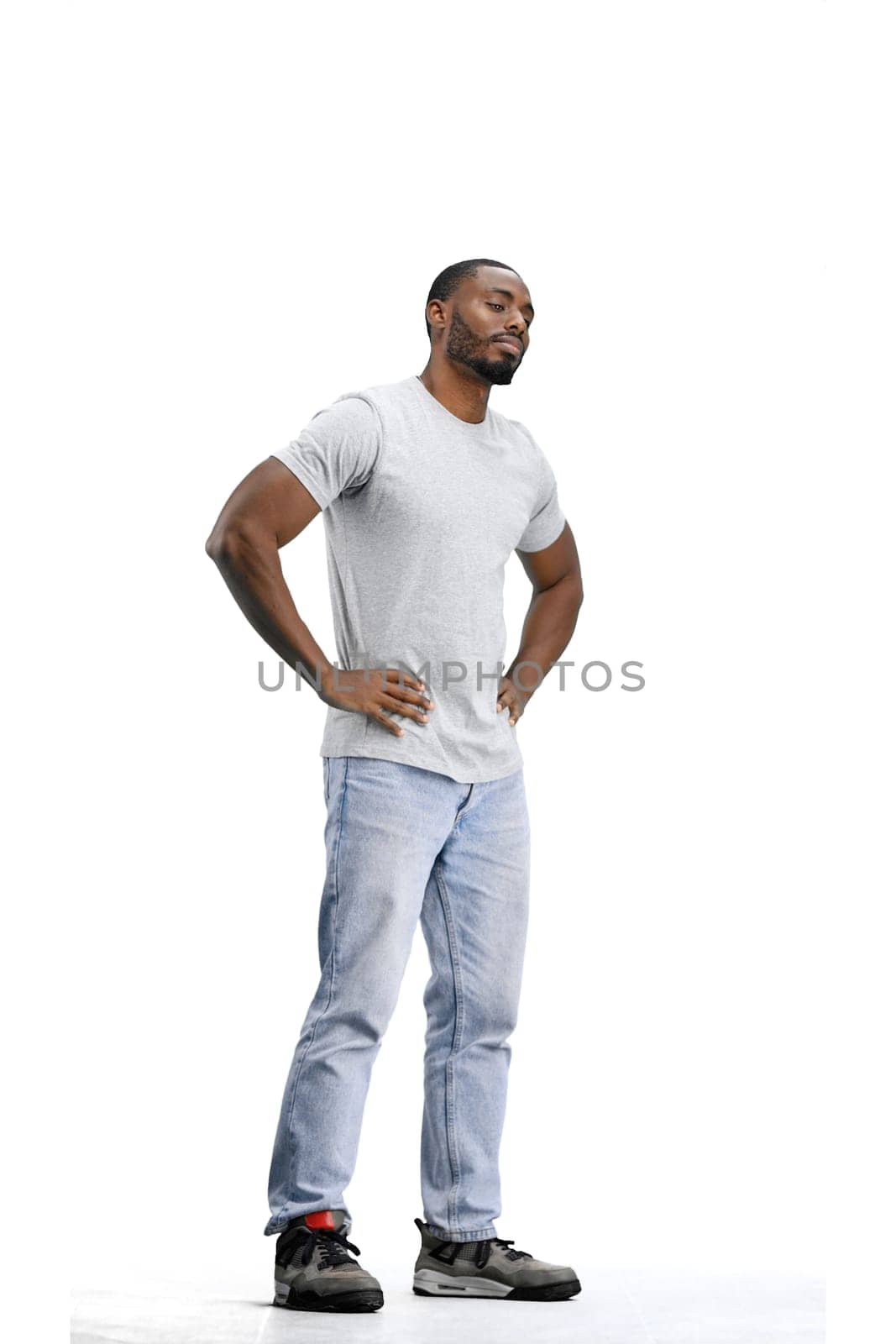 Man, full-length, on a white background, hands on hips by Prosto