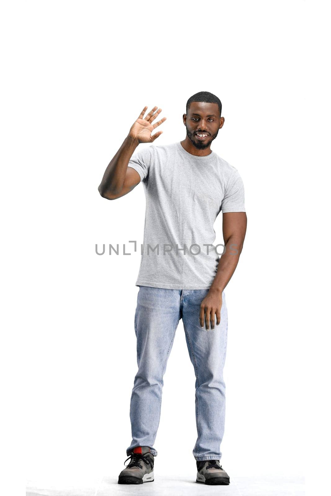 A man, full-length, on a white background, waving his hand.