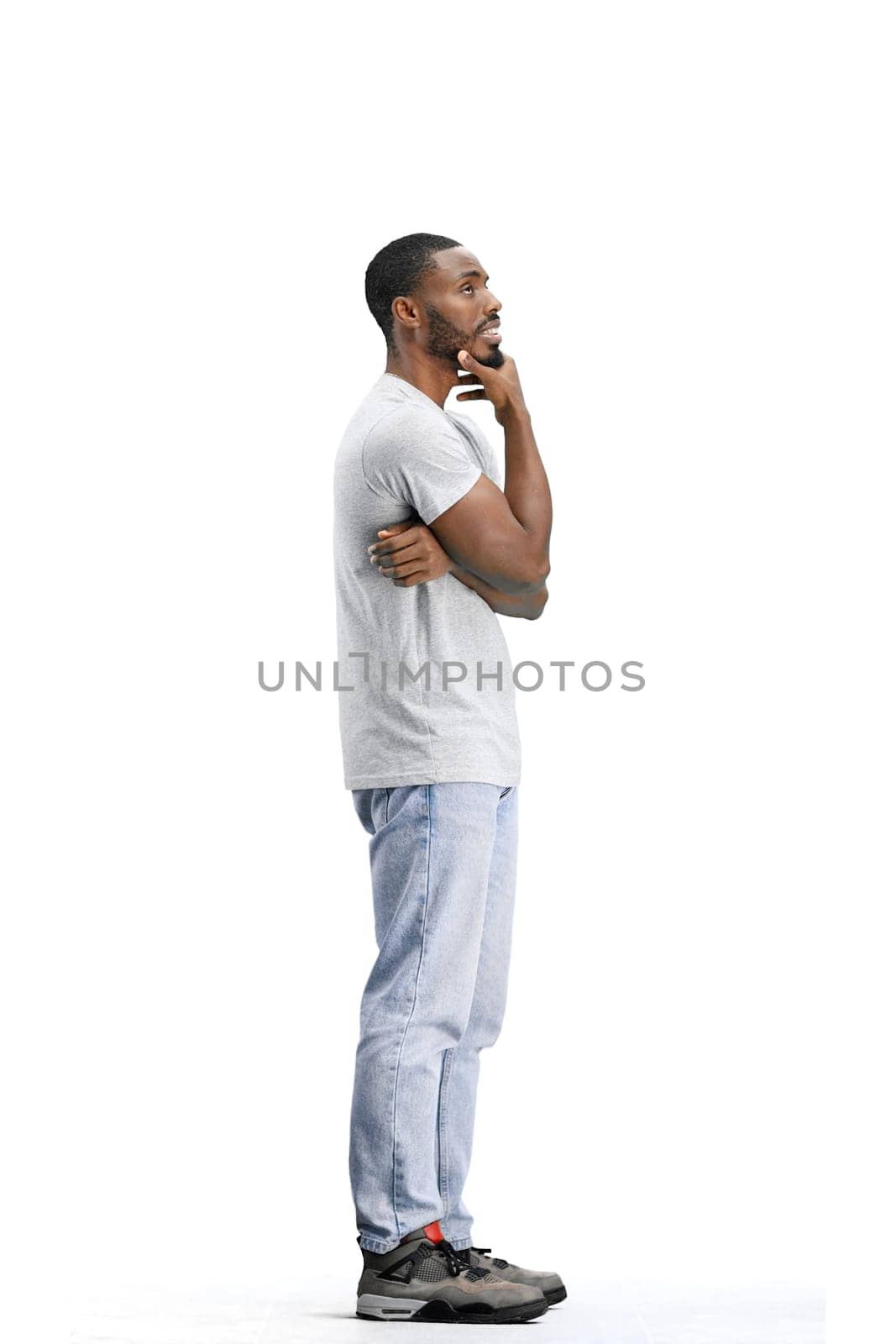 A man, full-length, on a white background, thinks.