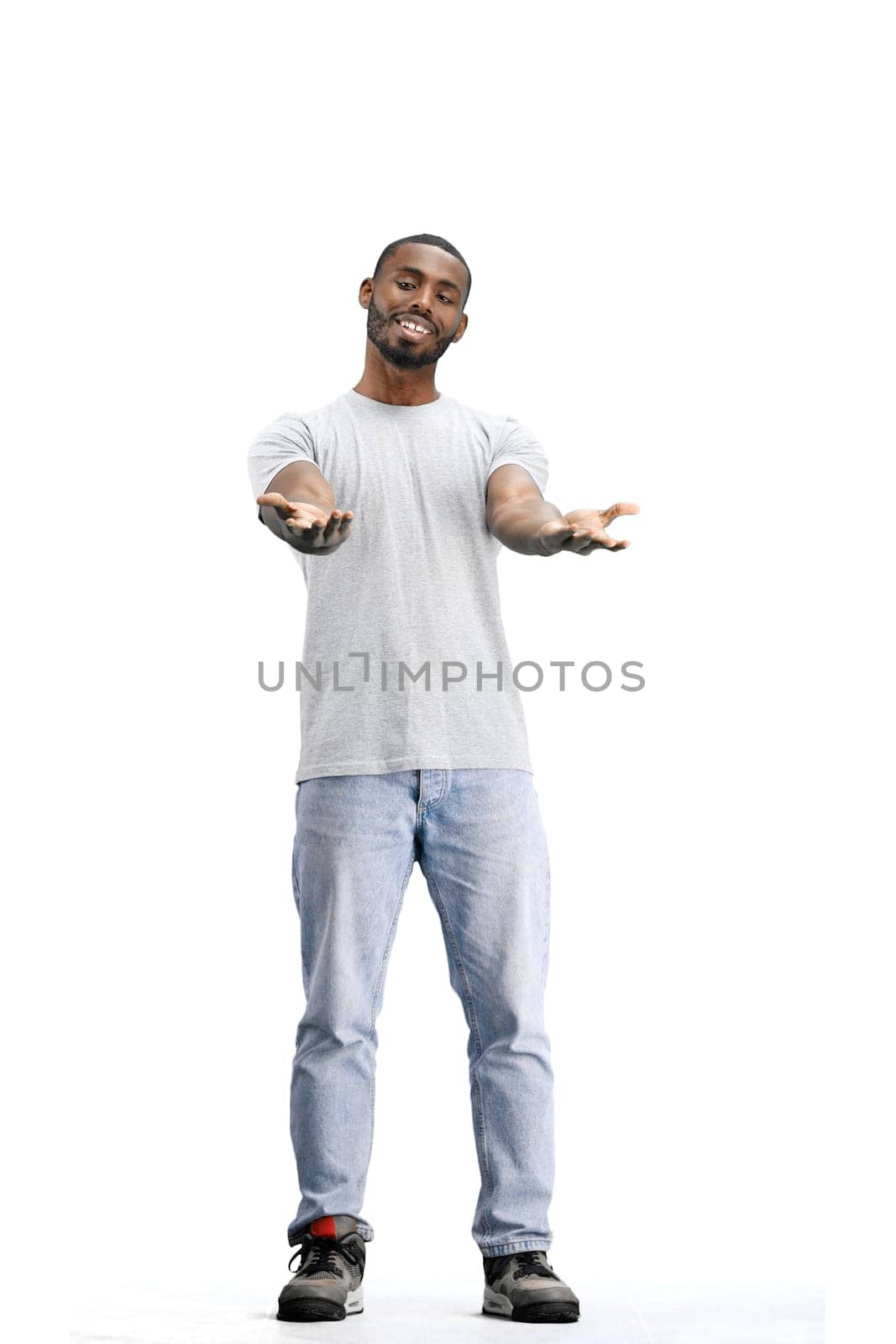 A man, full-length, on a white background, spreads his arms.