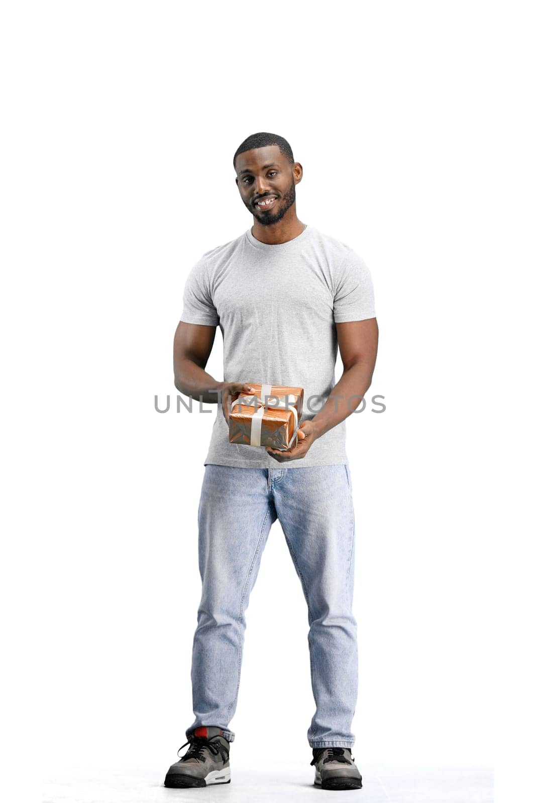 A man, full-length, on a white background, with a gift.