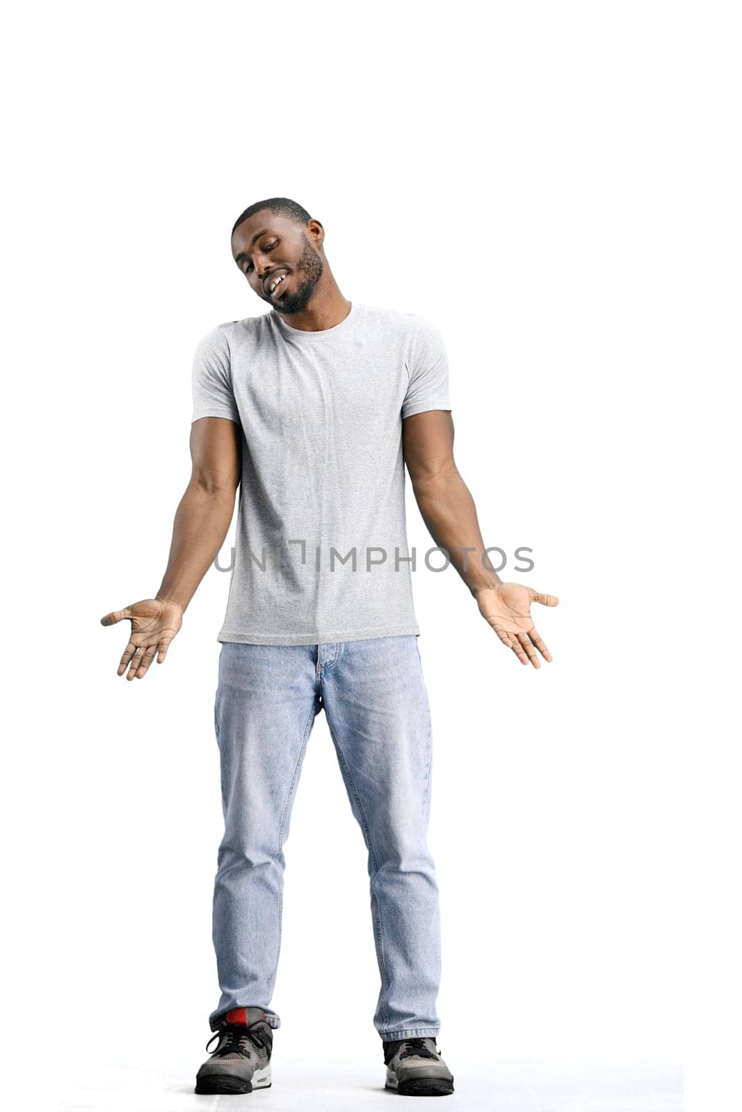 A man, full-length, on a white background, spreads his arms.