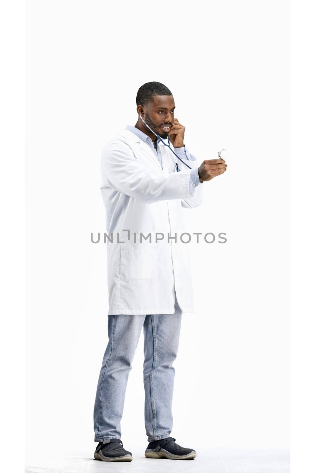 Doctor, full-length, on a white background, with a stethoscope.