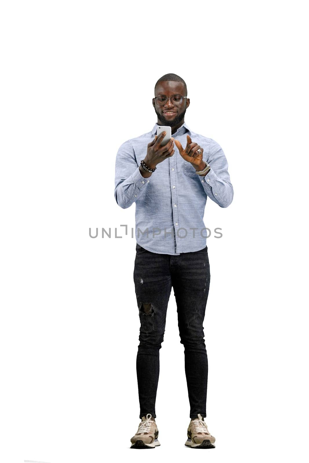 A man, full-length, on a white background, with bags and a phone.