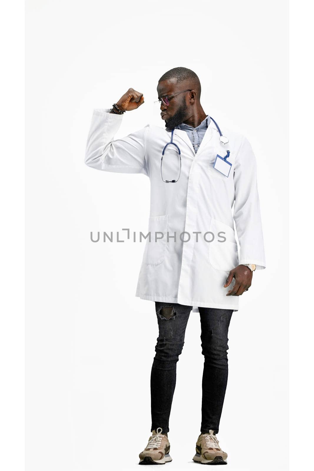 The doctor, in full height, on a white background, shows strength by Prosto