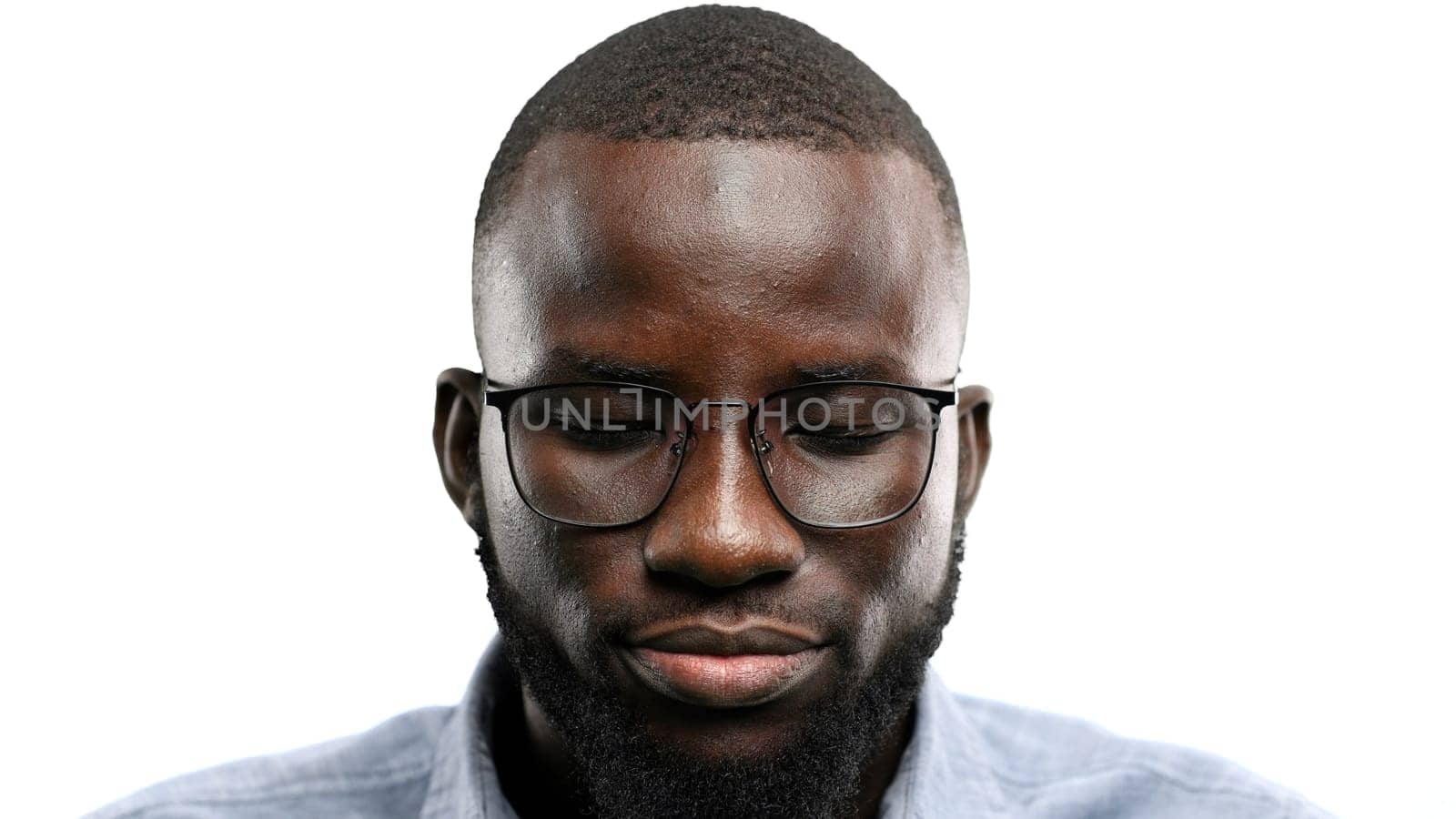 Man's face, close-up, on a white background.