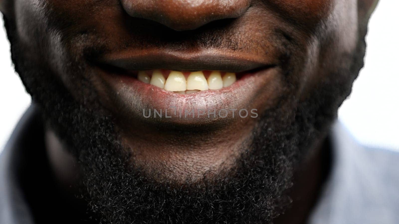 Man's mouth, close-up, on a white background.