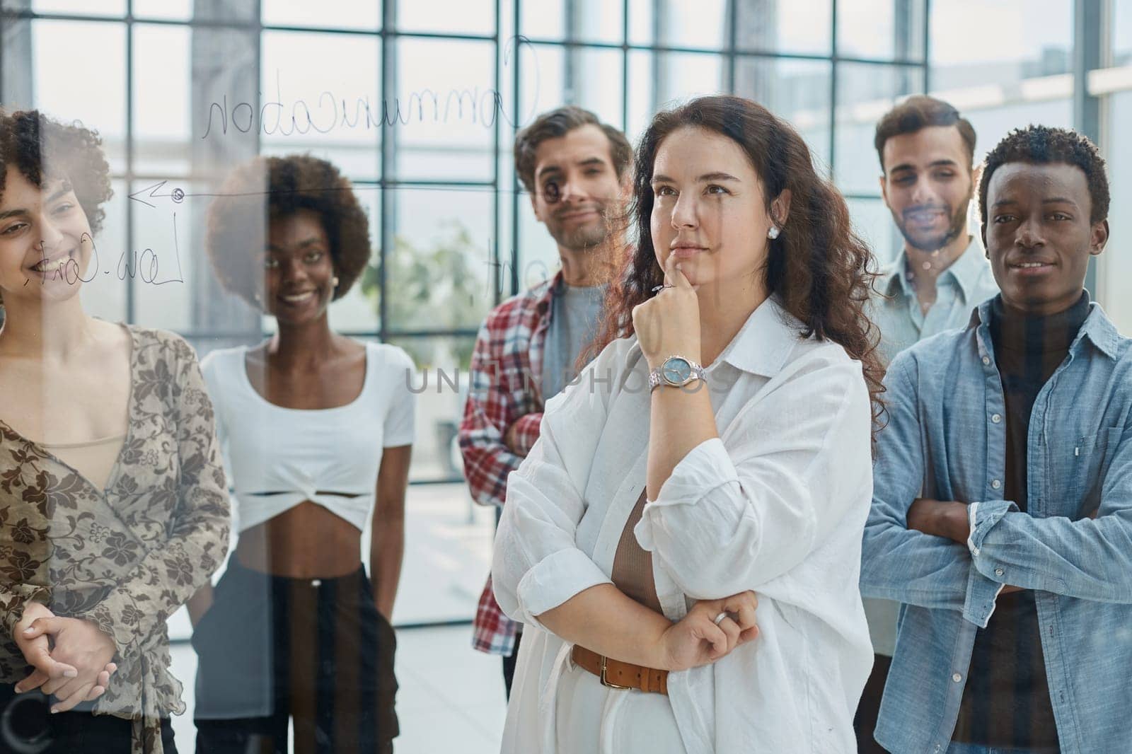 business woman with her staff in background at office by Prosto