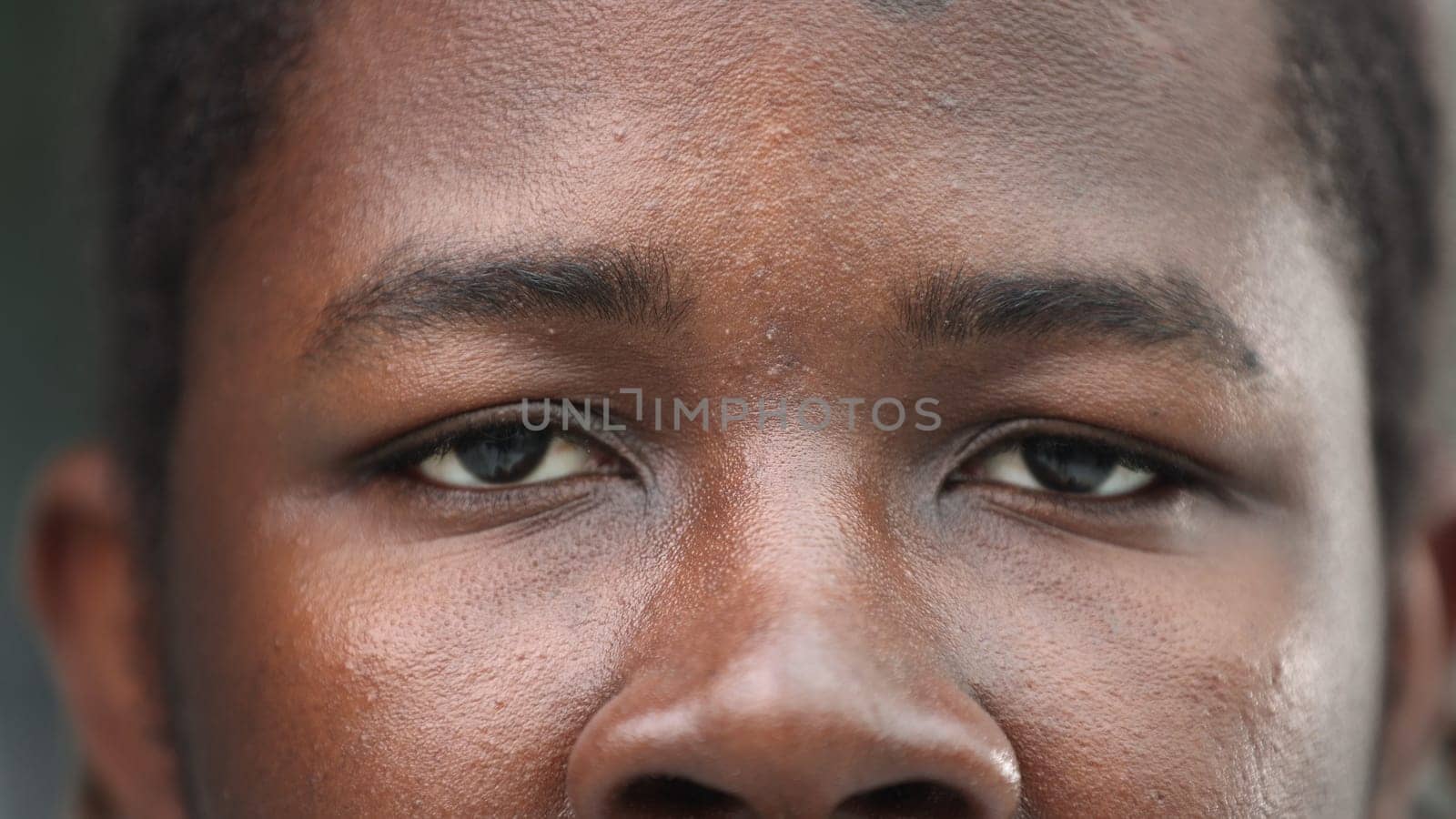 close-up of the face of a smiling African American man.