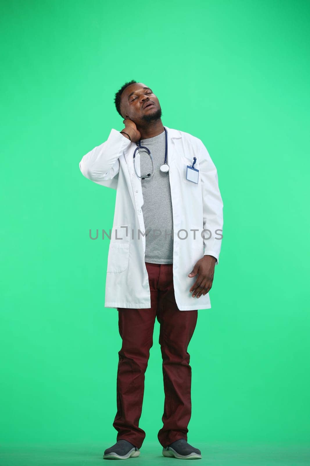 The doctor, in full height, on a green background, tired by Prosto