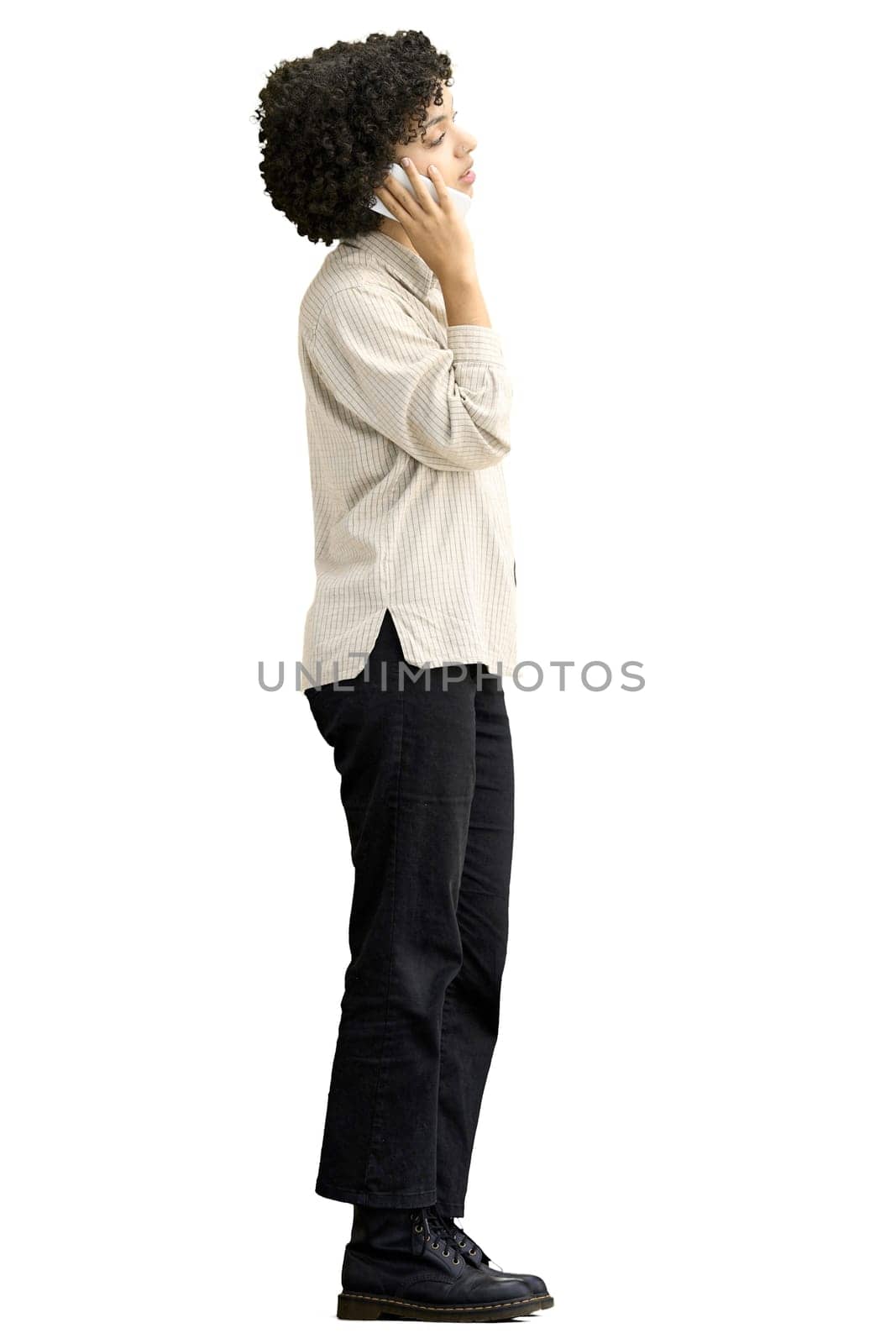 A woman, full-length, on a white background, with a phone.