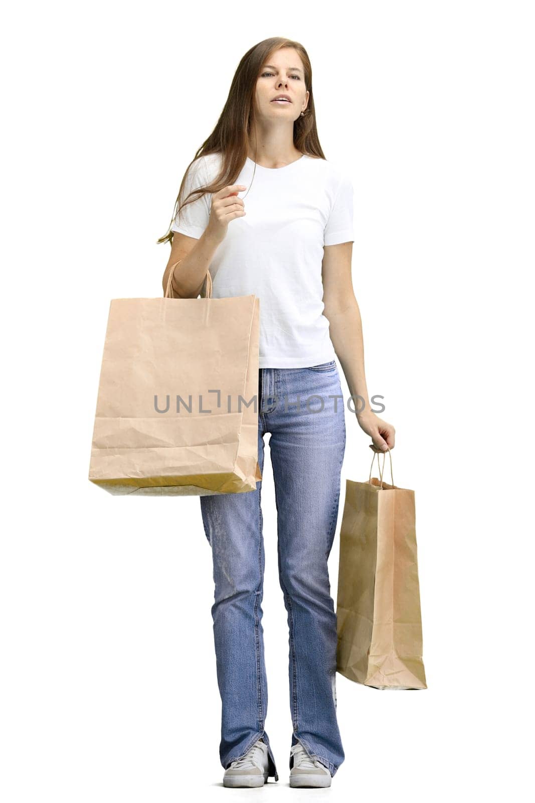A woman, full-length, on a white background, with bags.