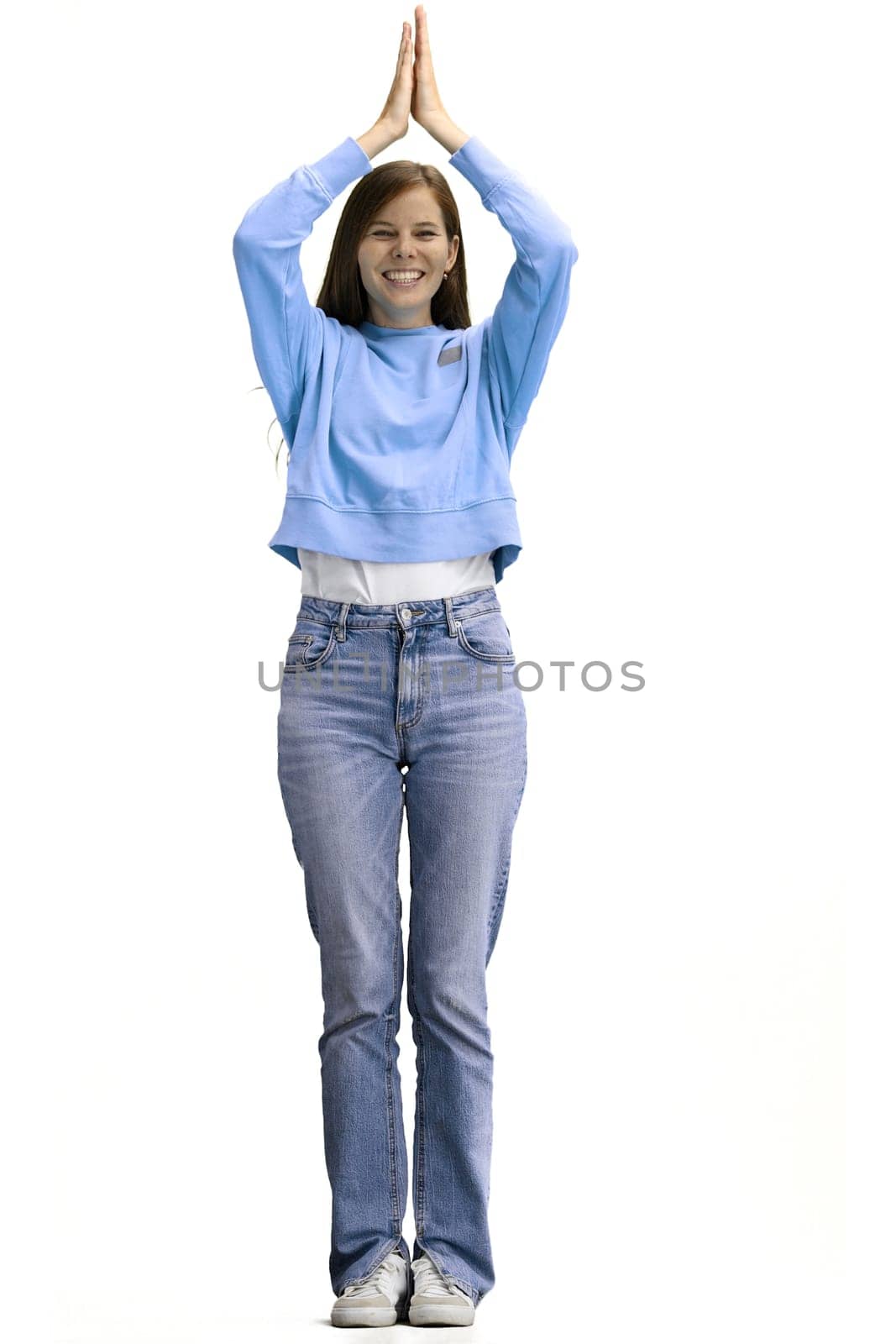 A woman, full-length, on a white background, claps.