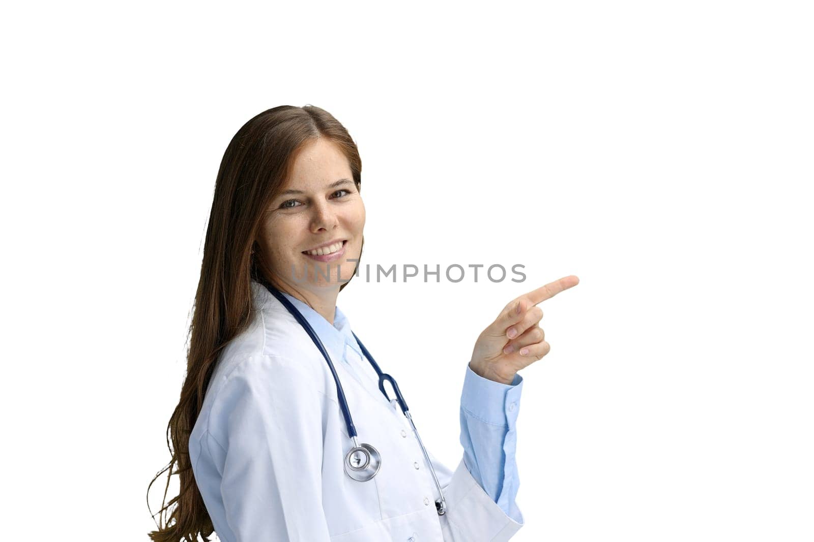 Female doctor, close-up, on a white background, pointing to the side by Prosto