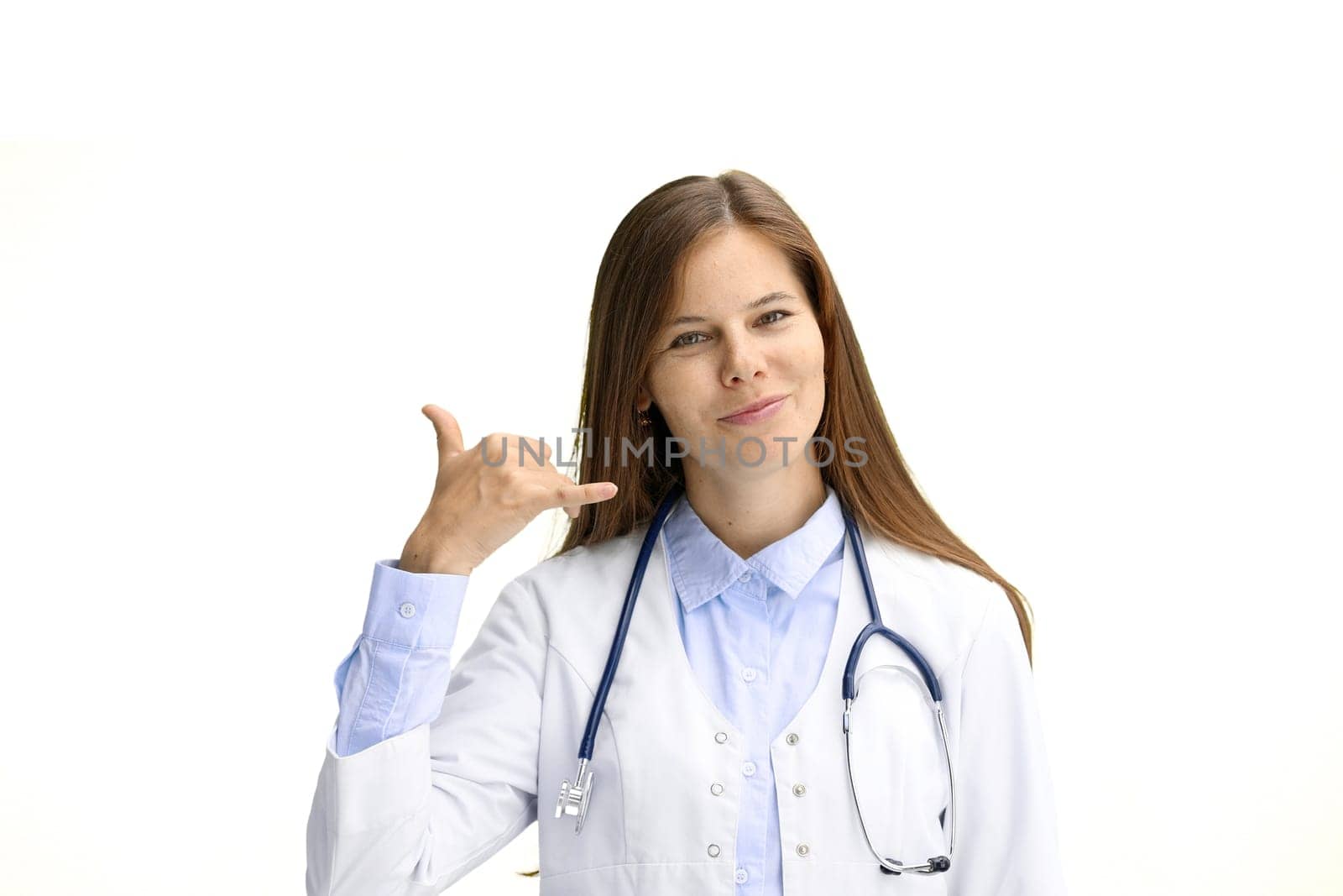 Female doctor, close-up, on a white background, shows a call sign.