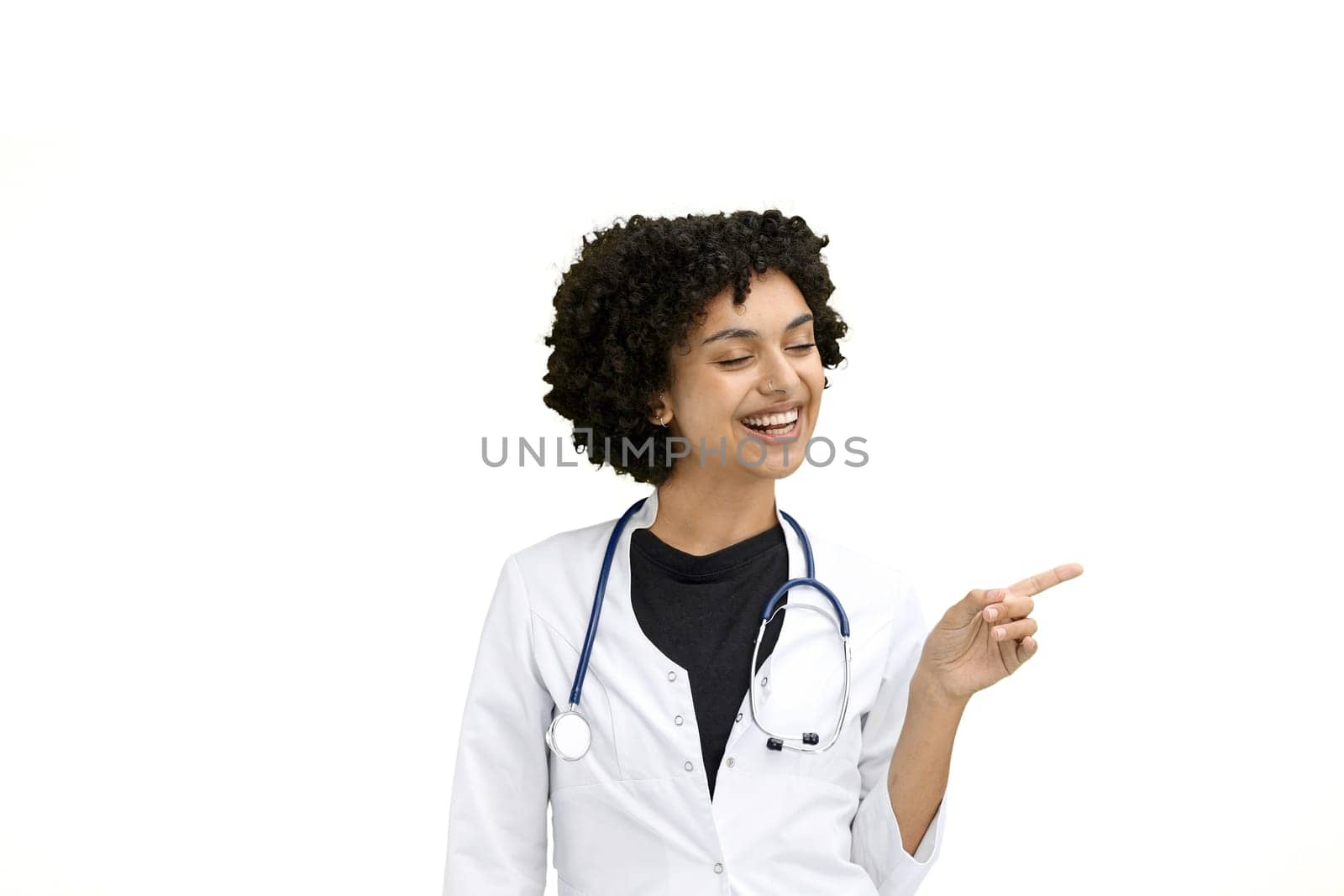 Female doctor, close-up, on a white background, pointing to the side by Prosto