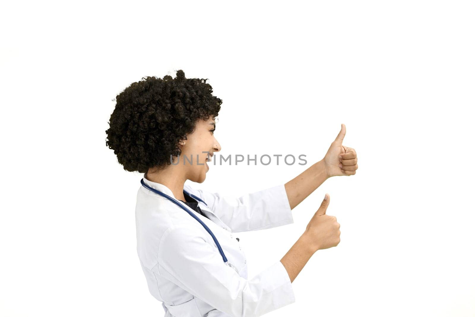 Female doctor, close-up, on a white background, shows thumbs up.