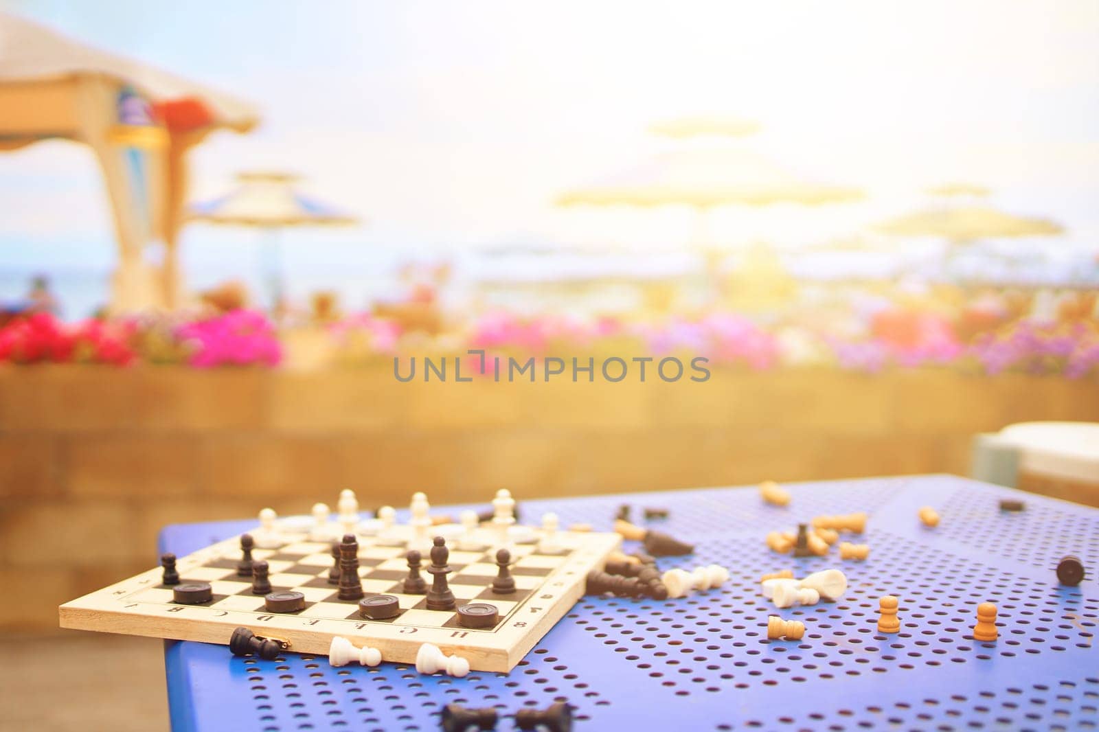Scattered chess summer day on the table in the hotel on the beach