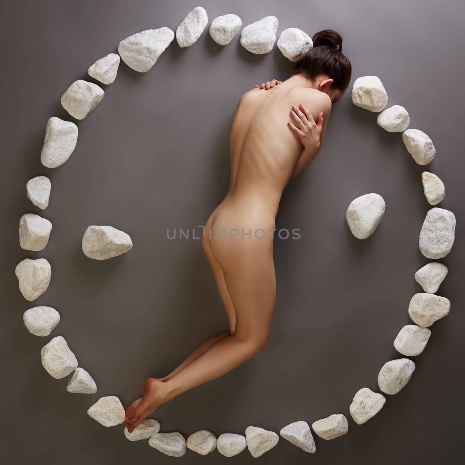 Yin-yang. Nude woman posing with stones by rivertime