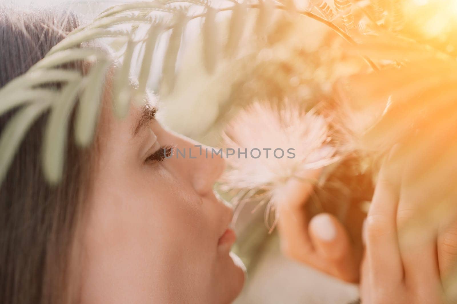 Beauty portrait of happy woman closeup. Young girl smelling Chinese acacia pink blossoming flowers. Portrait of young woman in blooming spring, summer garden. Romantic vibe. Female and nature by panophotograph