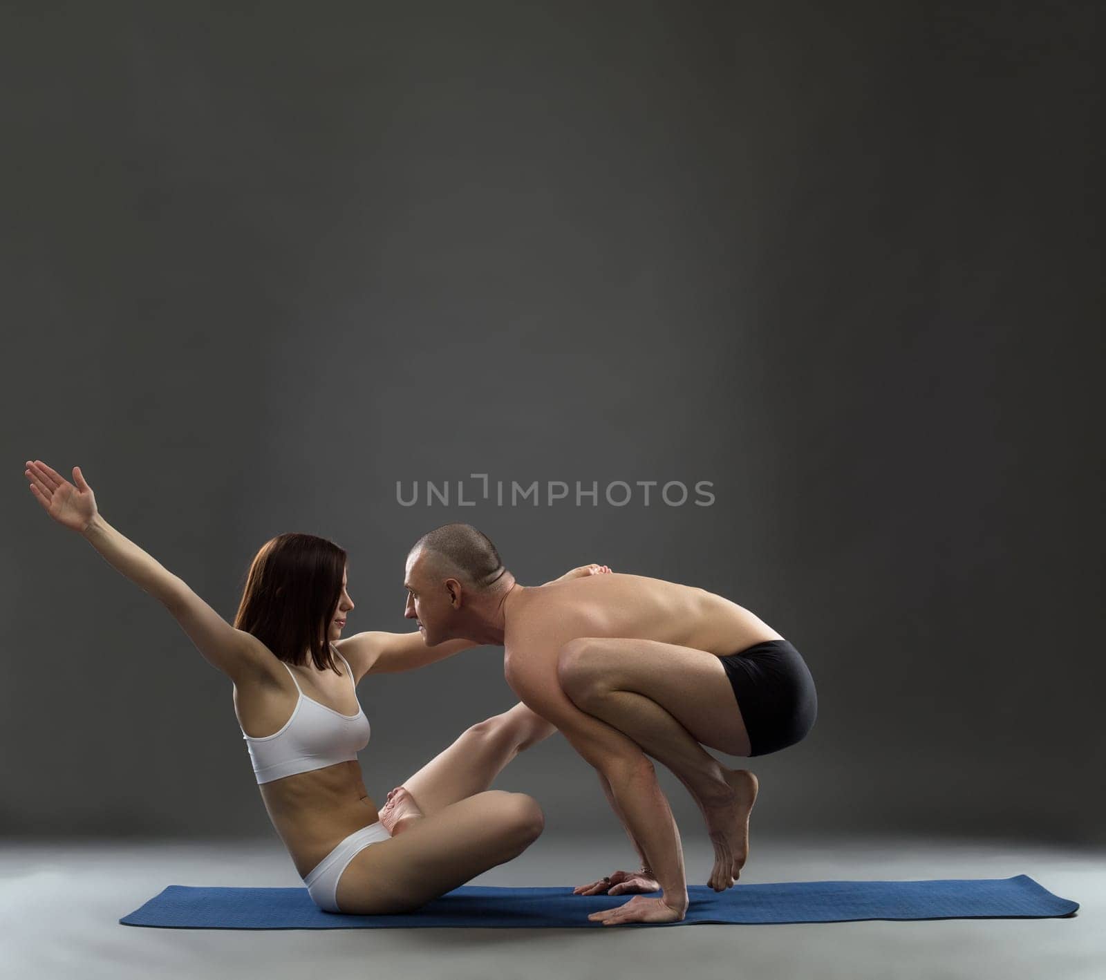 Yoga. Image of trainers posing in difficult asana by rivertime