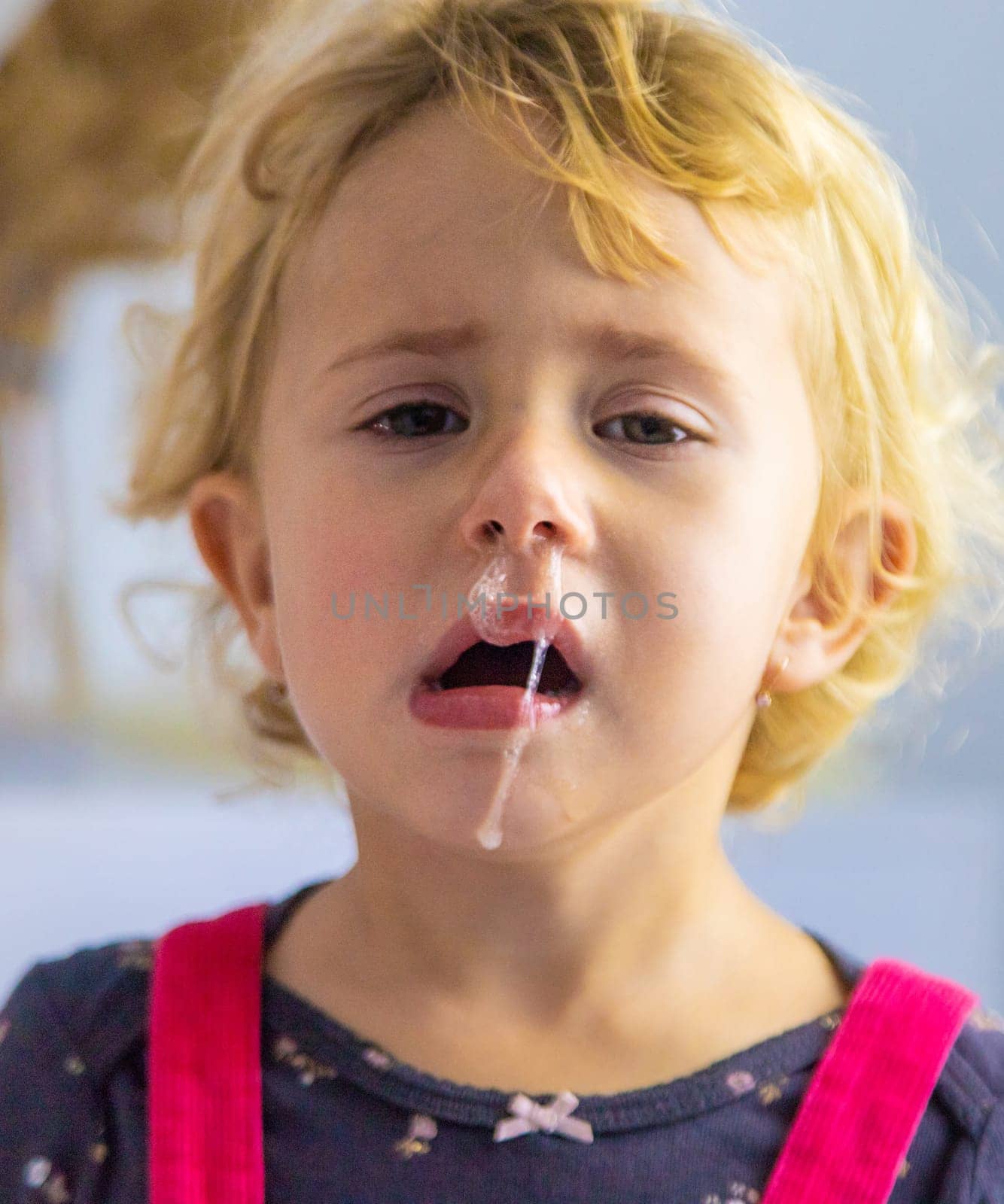The child has snot, the child is crying. selective focus. by yanadjana
