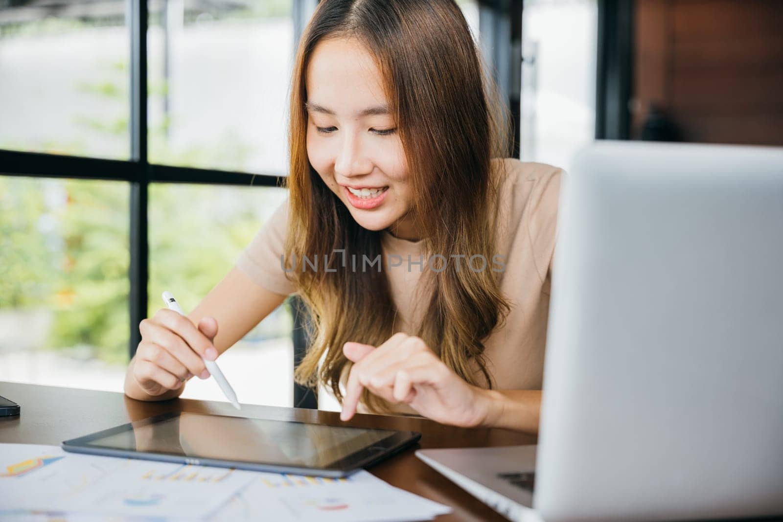 Smiling woman freelance artistic draw on screen, Lifestyle artist creative work painting drawing on touch pad digital tablet with stylus pen at cafe coffee shop, designer working online