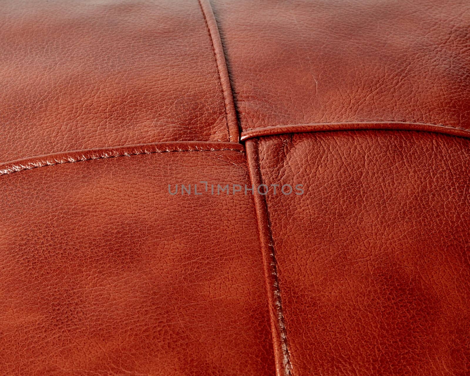Background of stitched square patches of copper-coloured leather by nazarovsergey