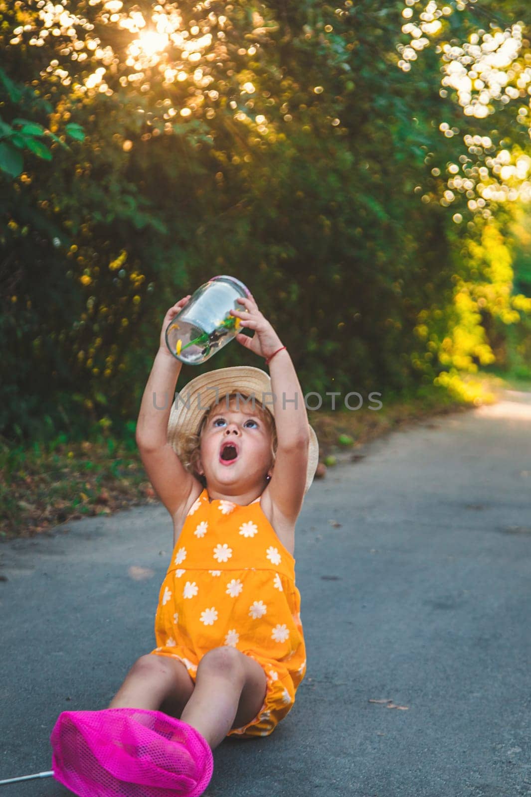 A child catches a butterfly in nature. selective focus. kid.