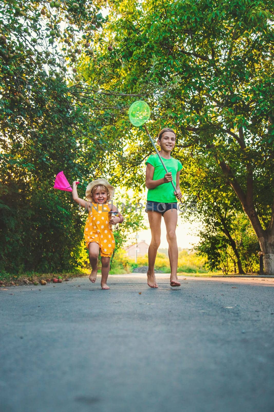 A child catches a butterfly in nature. selective focus. by yanadjana