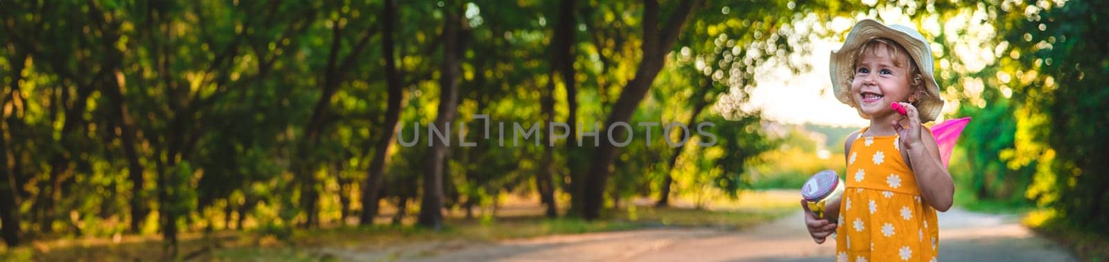 A child catches a butterfly in nature. selective focus. kid.