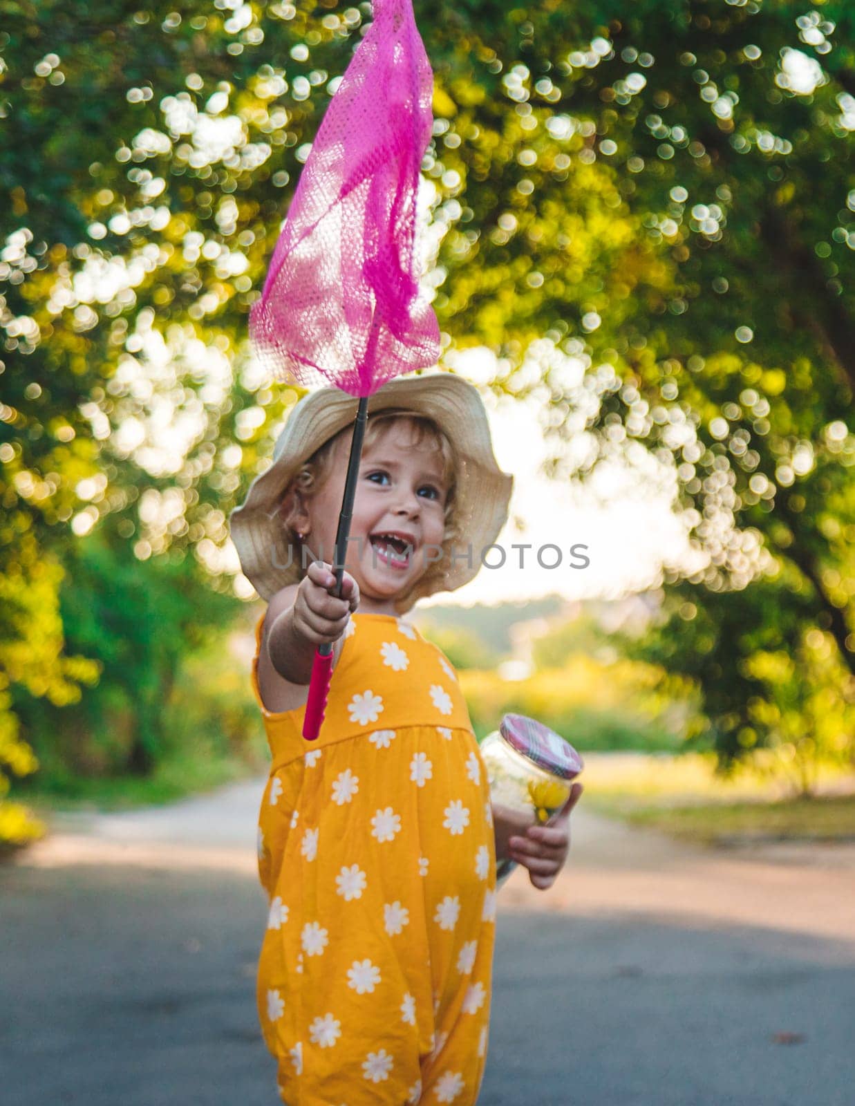 A child catches a butterfly in nature. selective focus. by yanadjana