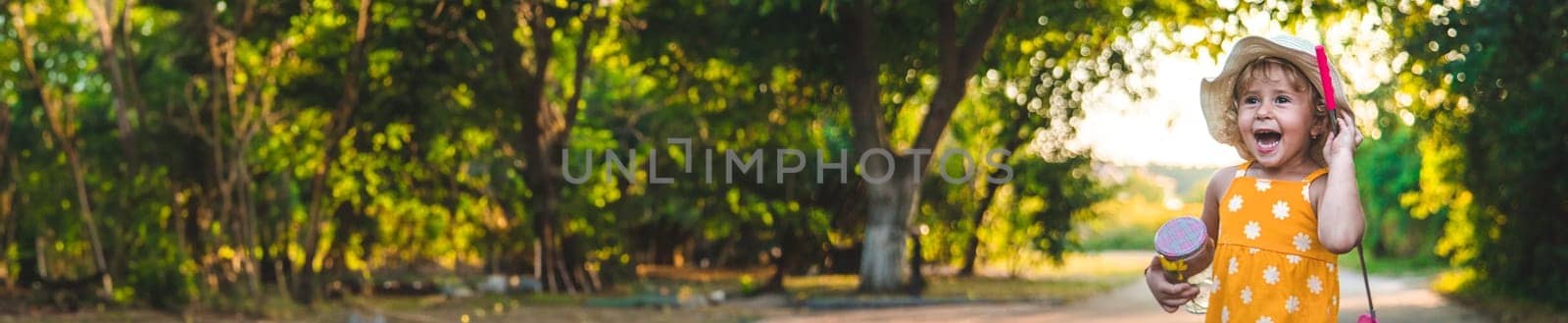 A child catches a butterfly in nature. selective focus. kid.