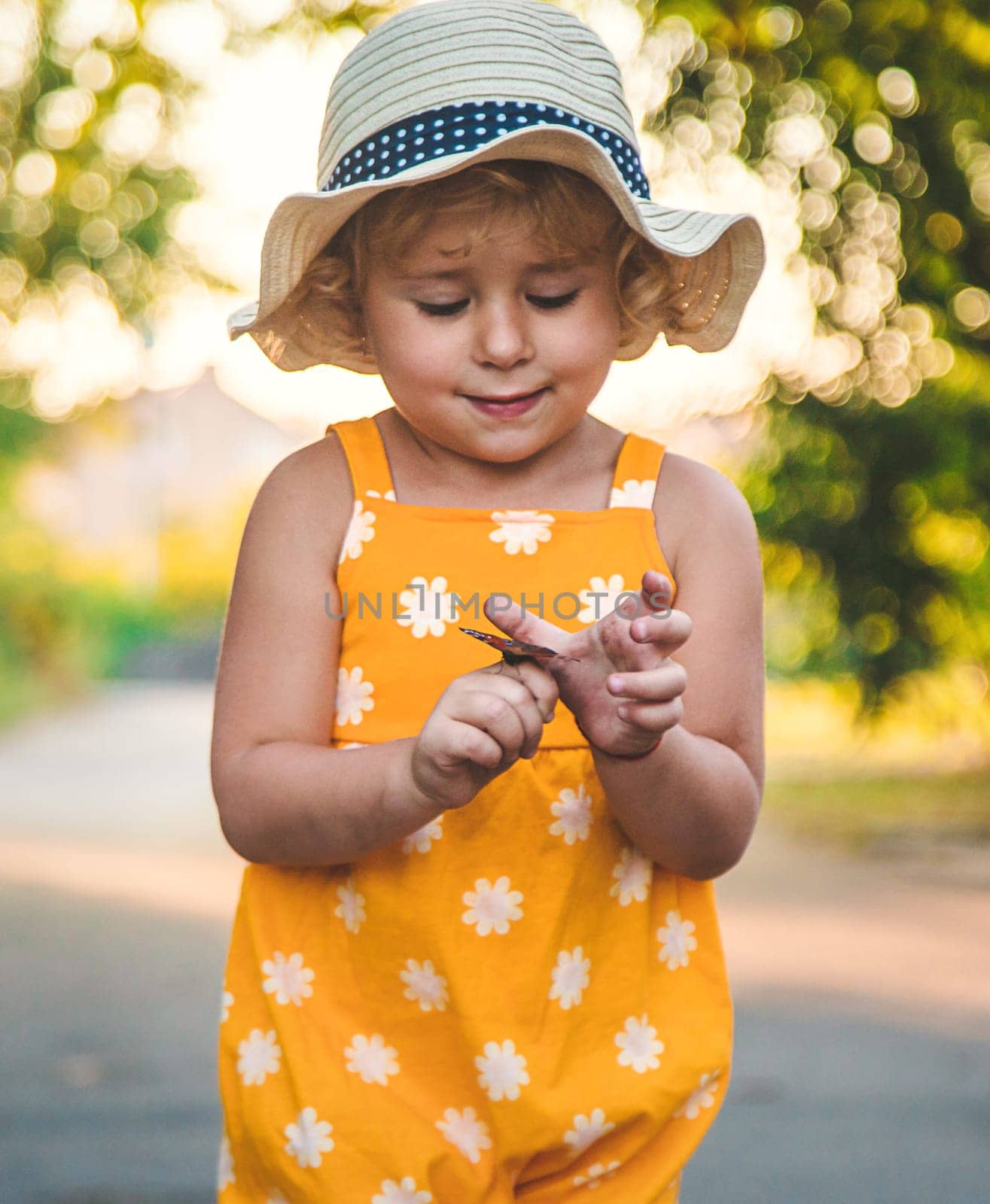 A child catches a butterfly in nature. selective focus. by yanadjana