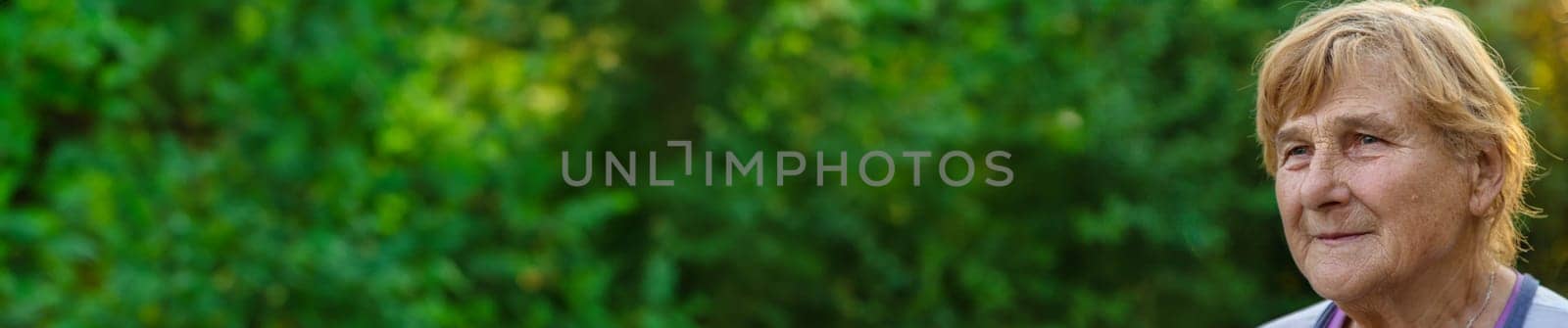 Elderly woman portrait in the garden. selective focus. Nature.