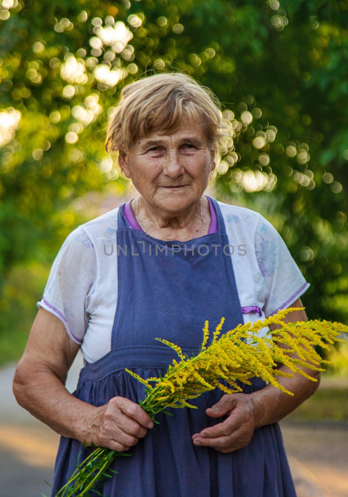 An elderly woman is allergic to ragweed. selective focus. Nature.