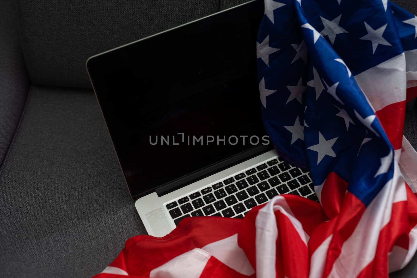 US flag and laptop on background with copy space