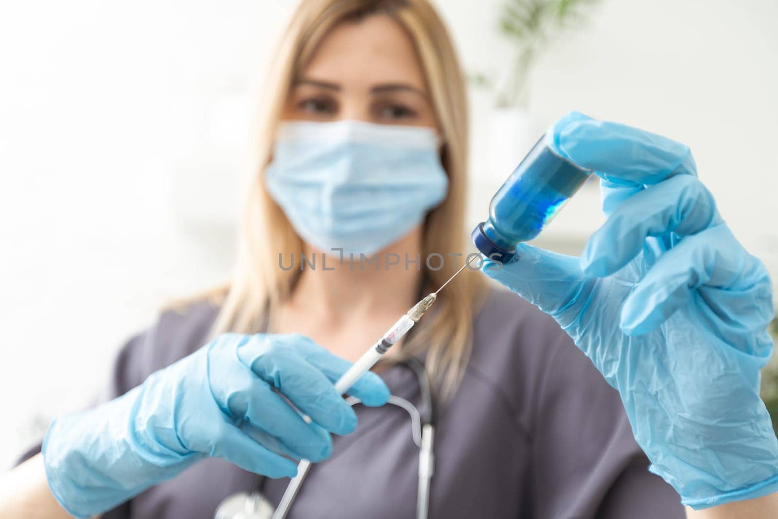 COVID-19 vaccine in researcher hands, female doctor's holds syringe and bottle with vaccine for coronavirus cure. Concept of corona virus treatment, injection, shot and clinical trial during pandemic