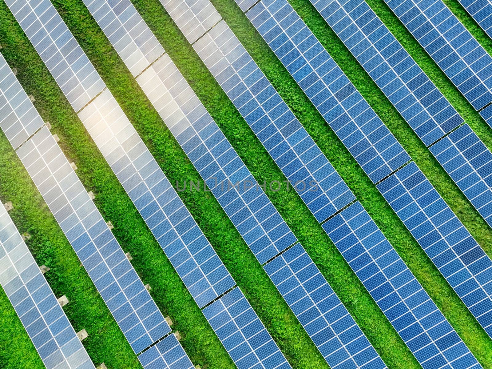 Aerial view of solar farm. Renewable energy for a sustainable future. Sustainable energy innovation. Solar energy. Clean power. Green technology.  Electricity generation. Photovoltaic power station. by Fahroni