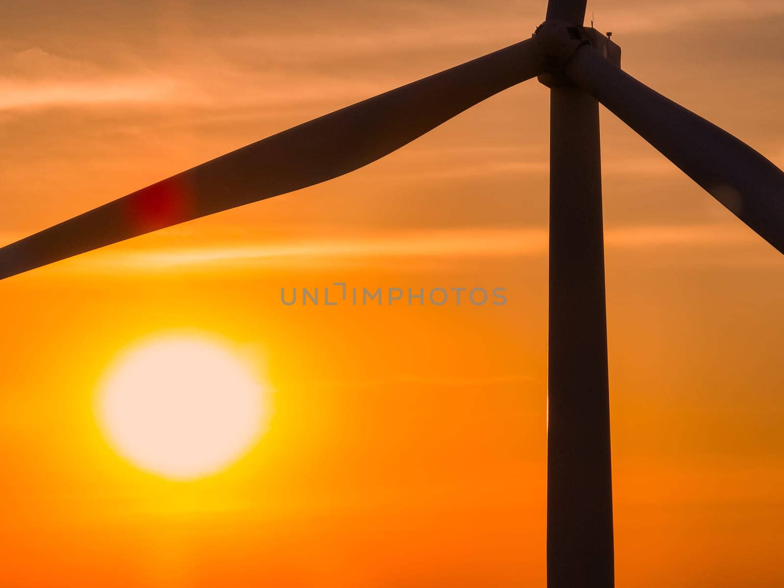 Wind farm field and sunset sky. Wind power. Sustainable, renewable energy. Wind turbines generate electricity. Sustainable development. Green technology for energy sustainability. Eco-friendly energy. by Fahroni