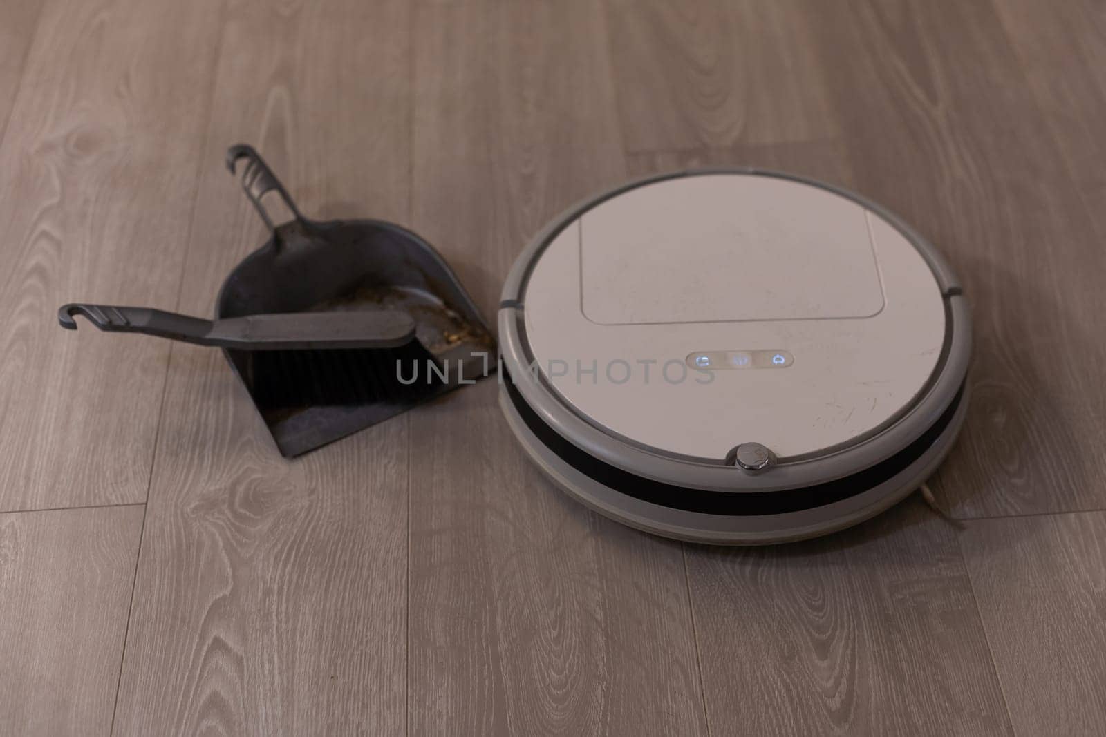 robotic vacuum cleaner on laminate wood floor smart cleaning technology. High quality photo